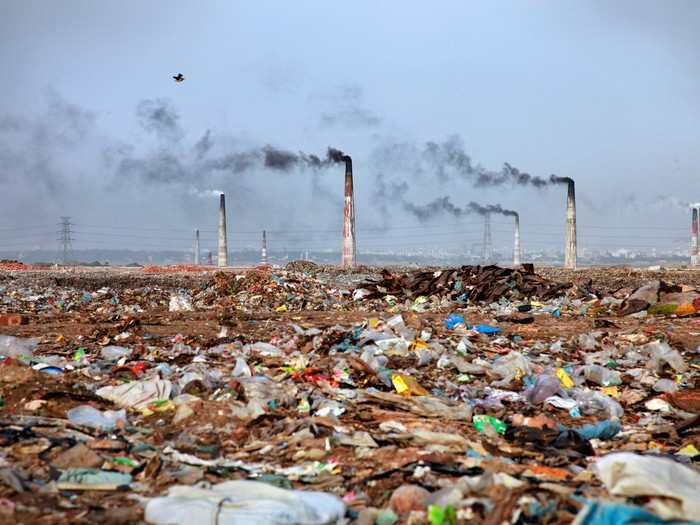 Brick kilns poke up above a dystopian landscape of trash in Bangladesh. Every day, 3,500 tons of garbage is produced in Dhaka, the capital city, and almost half goes uncollected.