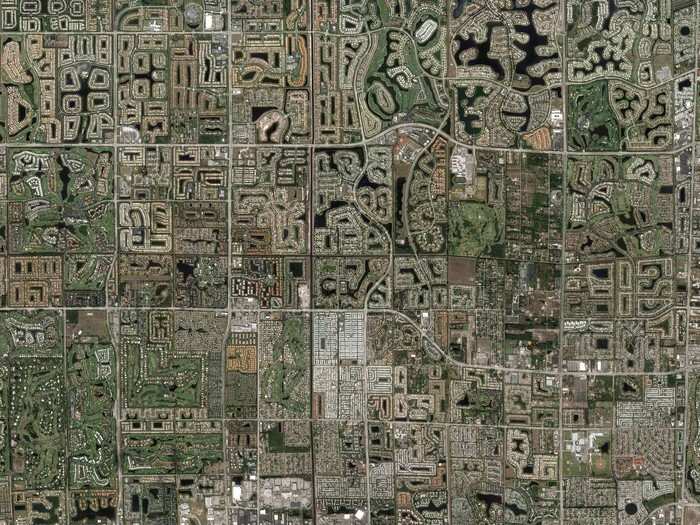 This view from above of the landscape outside Miami, Florida, shows 13 golf courses amongst tract homes on the edge of the Everglades. The area has suffered from depleting water resources, as well as a surge in people moving to the area and developing the land.