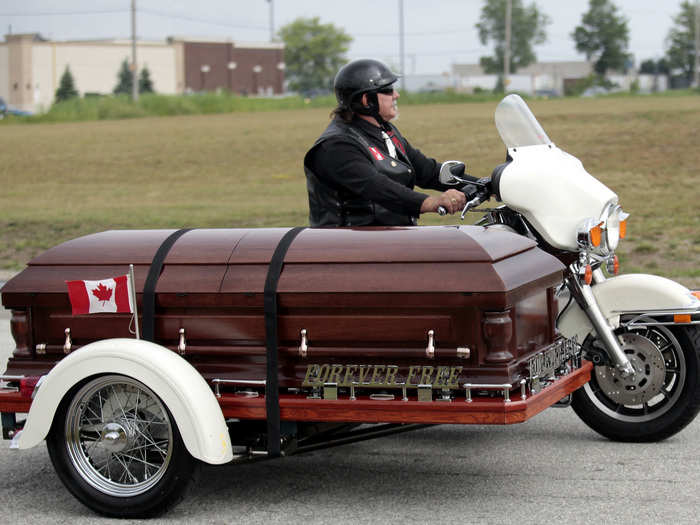 Former NHL hockey player, Bob Probert, rode out in style on a motorcycle side-car.