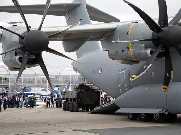 Visitors look into the belly of the behemoth Airbus A400M military transport plane.