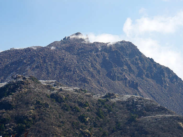 Mount Unzen, shown here with its neighbor, Mount Fugen-dake, is part of a an active group of stratovolcanoes near the city of Shimabara on the island of Kyushu. In 1792, one of its lava domes collapsed and produced a tsunami that killed about 15,000 people. It lay dormant for nearly 200 years, before erupting again from 1990-1995.