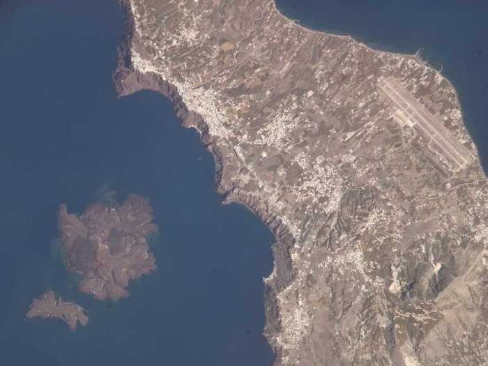 Santorini, seen in this photograph taken by an crewmember on the International Space Station, is a Greek island in the Aegean Sea formed by a volcanic caldera, the cauldron-like volcanic features formed when a volcanic eruption causes surrounding land to collapse. Once known as Thera, the island was created by layers of lava produced by overlapping shield volcanoes. Its 4th and most recent major eruption, in 1620 B.C., created the islands and bay visible today.