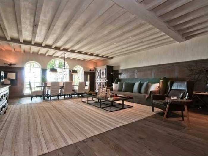 The spacious living area is outfitted with 150-year-old, reclaimed hardwood floors.