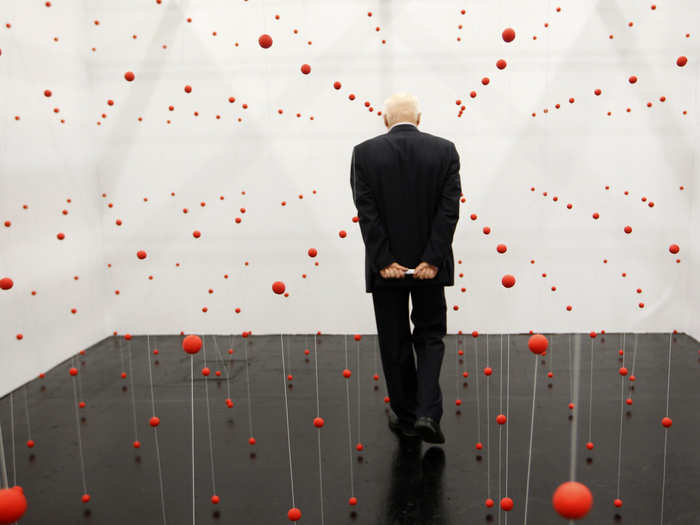 Crimson spheres create an abstract grid that surrounds visitors in Katharina Hinsberg