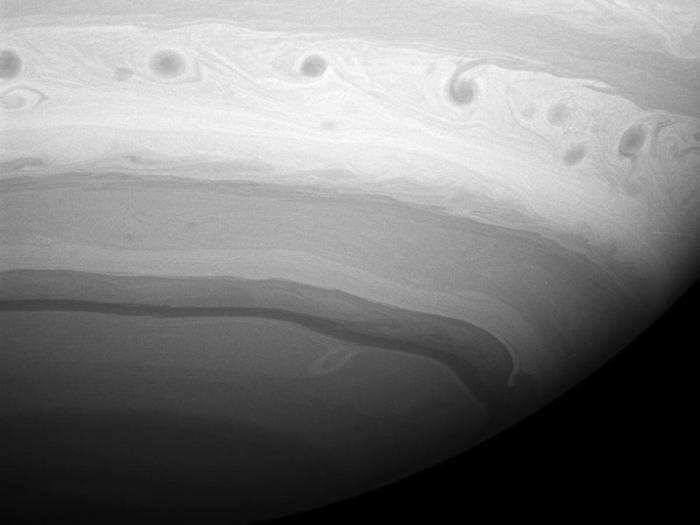 These curlicues etched along the southern hemisphere are actually giant vortices in one of Saturn