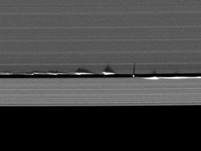 Cassini spots shepherd moons by the disturbances they leave as they move through the rings. Here