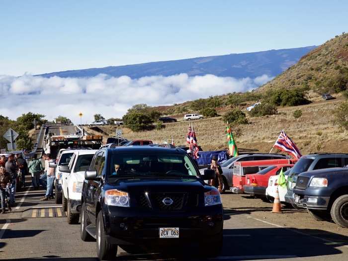 Their goal was to block this caravan of trucks headed to the summit. Hawaii gave approval to resume construction after the first wave of protests in April forced a two-month delay.