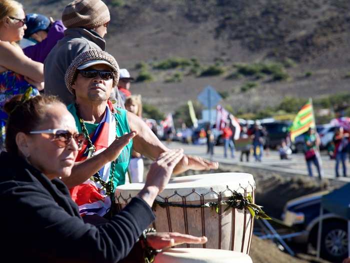 Two native Hawaiians drummed from the roadside, giving rhythm to the marching and chanting.