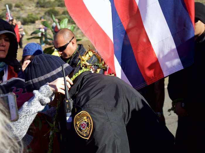 Children in the protest group presented leis to the police officers and DLNR staff. It