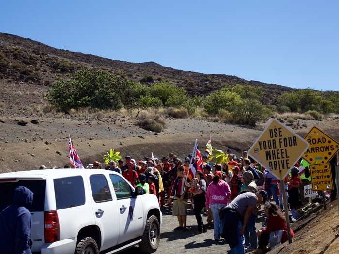 After a few hours of inching forwrd, the caravan reached the end of the paved path. Protestors blocked the steep gravel access road that winds toward summit.