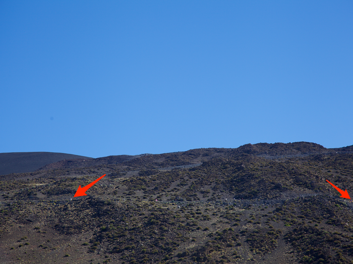 But earlier that morning, some protesters had driven up the mountain. Shading my eyes, I spotted a few groups waiting several miles up for the caravan. Some of them dragged large rocks onto the gravel road to block the trucks.