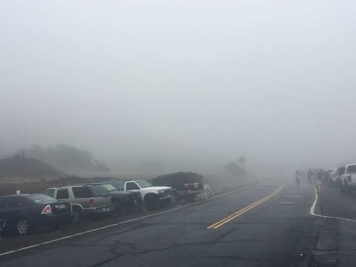 Then it began to rain. Several protestors said it was "the heavens weeping for what is happening on Mauna Kea today." You could barely see anything ahead through the mist. About two miles up the gravel road, the rocks and rain forced DLNR officials to turn the construction caravan around.