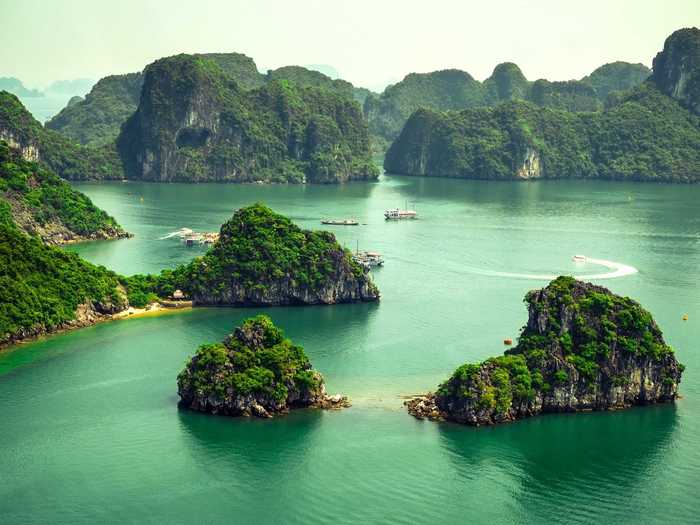 Ha Long Bay, in the Gulf of Tonkin off the coast of Northern Vietnam, is made of about 1,600 islands and islets of limestone pillars. According to UNESCO, a majority of the islands are uninhabited by people due to their extremely steep nature.