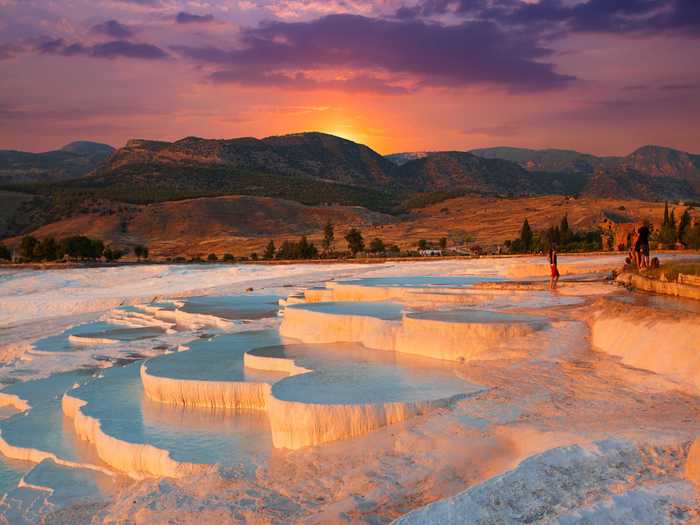 The natural terraced thermal springs of Hierapolis-Pamukkale in the province of Denizli, Turkey, date as far back as the second century BC. Formed by calcite in the waters, the hot springs look like stunning white clouds.