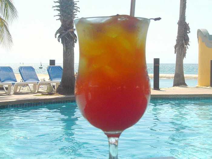 The Aruba Ariba is a popular drink choice in Aruba. It combines Coecoei, made from the sap of agave plants, with vodka, rum, creme de Banana, orange juice, cranberry juice, pineapple juice, and a splash of Grenadine.