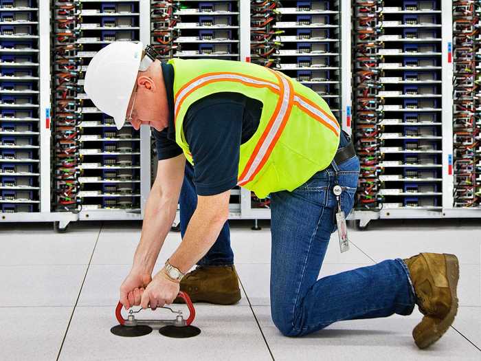 This is Jon Rogers at the North Carolina data center using what it calls a "floor-tile-grabber" to check the status of the pipes underneath.