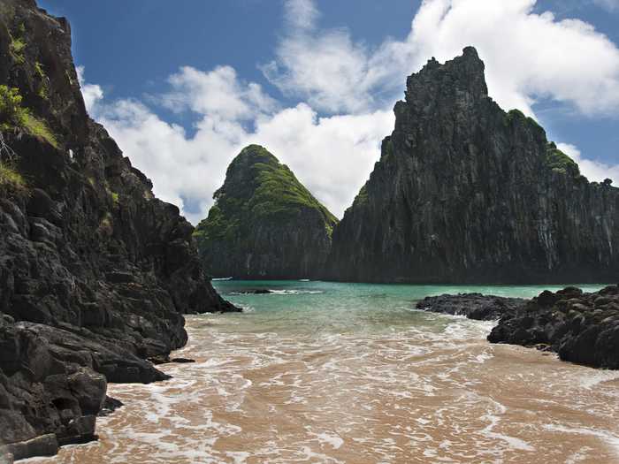 Fernando de Noronha, an archipelago of 21 islands and islets located 220 miles off of the Brazilian coast, was declared a marine national park in 1988 and allows only 420 tourists on the island at a time. Because of that, you’ll find unspoiled beaches teeming with dolphins and sea turtles amidst stunning waterfalls.