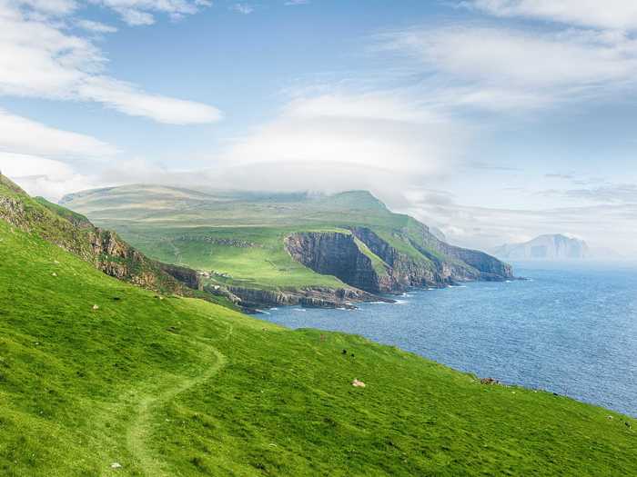 Mykines is the most westerly of the 18 main islands located in the Faroe Archipelago, which lies approximately halfway between Norway and Iceland. Here, villages are filled with grass-roofed houses and the island is known for its large population of puffins.