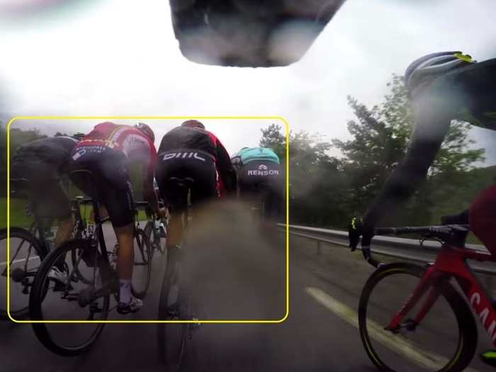 From deep inside the peloton we get to see the nervous moments — such as rain-soaked riders fighting for position and quite literally rubbing elbows. There are effectively four riders in a space that would normally allow for just three.