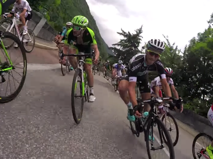 Seeing riders take tight turns this close at speed from inside the peloton is intense.