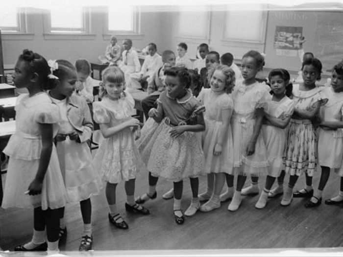 Schools around the country slowly began to integrate. Here, African-American and white students share a classroom at Barnard School in Washington, D.C. in 1955.