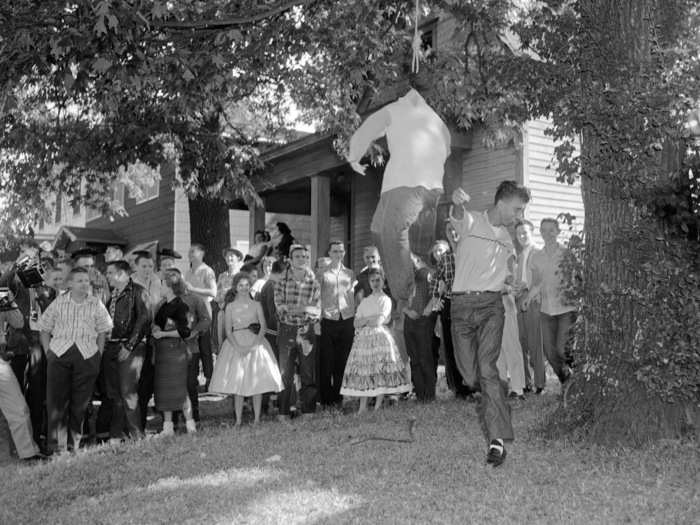 Members of the Little Rock, Arkansas community protested and tried to physically block the students from entering the school. Here, an unidentified while male punches an effigy of a black student.