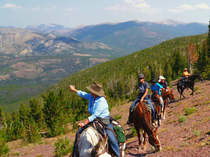 Go horseback riding on a mountain trail.