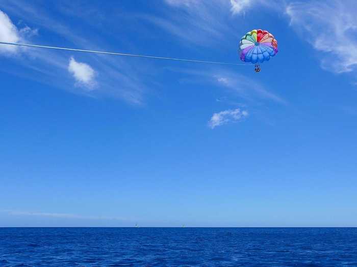 Go parasailing off the coast of Honolulu, Hawaii, and soar high above the ocean.