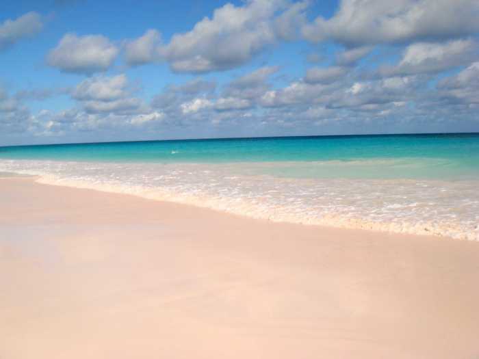 Broken coral pieces, shells, and calcium carbonate form the pink sands beaches found at Harbour Island in the Bahamas.