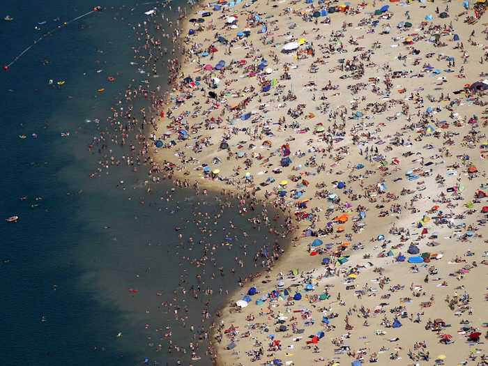 People flooded the shores of the Silbersee lake in Haltern, Germany to keep cool.