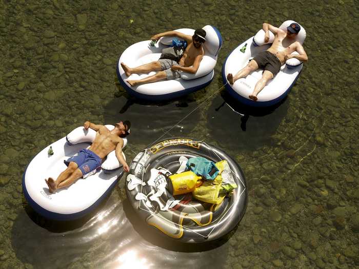 These three avoided the heat by riding rafts down the Sihl river in Zurich, Switzerland.