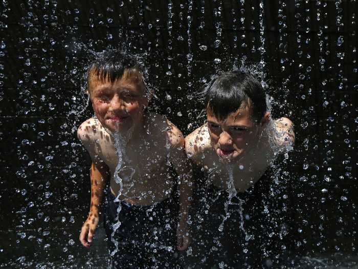 Two British youngsters sought relief in a fountain in Nottingham.