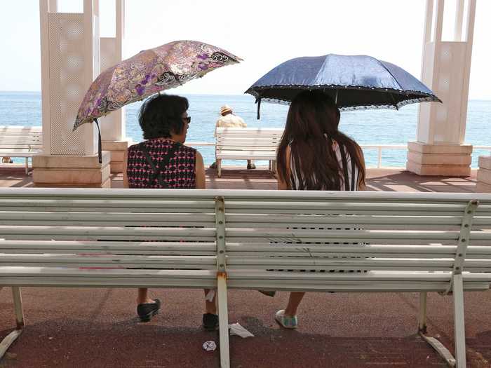 These two women made their own shade on the promenade des Anglais in Nice, France.