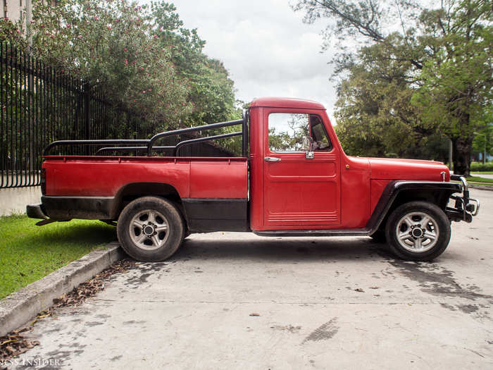 Mechanics have creatively married working parts from multiple cars to create these Frankenstein automobiles, like this red truck sitting outside of the Russian Embassy in Havana.