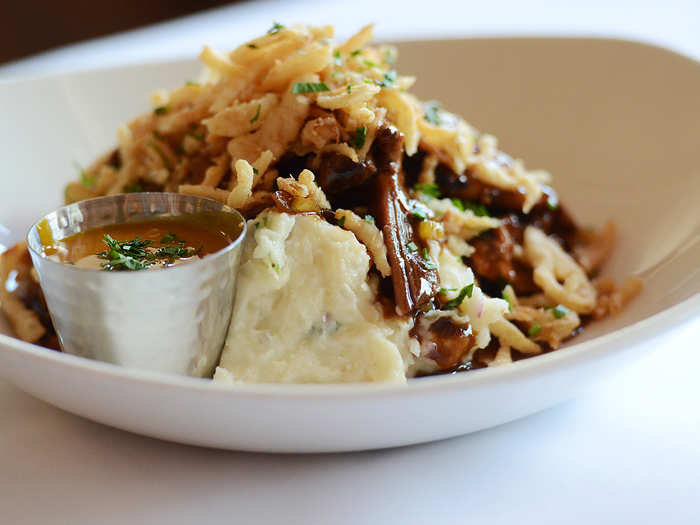 Cowboy Dave’s Cluck & Moo: Smashed potatoes, roasted beef and grilled chicken covered with beef gravy, crispy onions and mustard BBQ sauce.