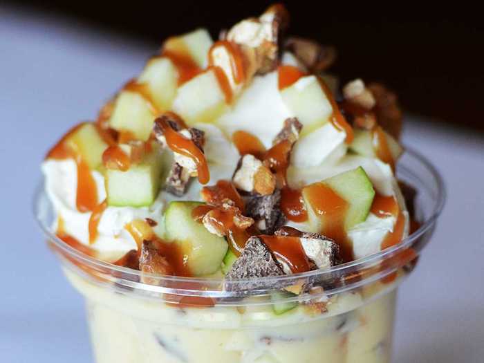 Grandma Deb’s Snicker Bar Salad: Chopped Snickers® bars and Granny Smith apples tossed in vanilla pudding with whipped cream and drizzled with caramel sauce.