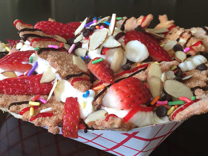 Italian Dessert Nachos: Cinnamon sugar cannoli chips smothered with sweet ricotta cheese filling, fruit, chocolate, nuts and candy toppings.