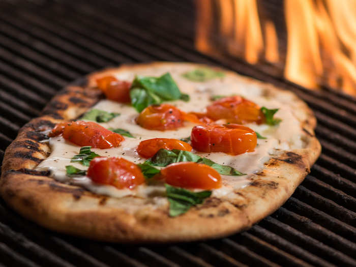 The Margherita: Topped with oven-roasted tomatoes, cheese and basil. Grilled over an open flame for a crispy crust.