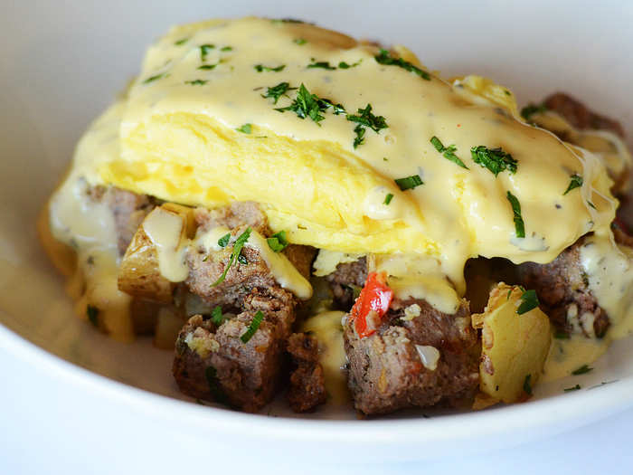 Meatloaf Hash: Blue Barn meatloaf, sautéed potatoes, peppers and onions topped with scrambled eggs and béarnaise sauce.