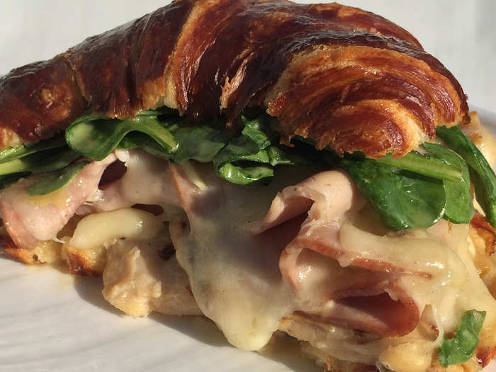 Pretzel Croissant Sandwich: Gluten-free and nitrate-free grilled chicken breast and ham, Swiss cheese and fresh spinach smothered in honey mustard and chive aioli, grilled and served hot on a pretzel dough croissant or gluten-free toast.