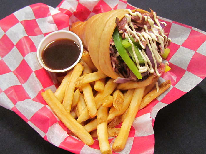 Prime Rib To Go: Thinly sliced choice prime rib, sautéed peppers, onions and mushrooms (optional) in a soft bread cone with a side of au jus, horseradish or Parmesan garlic sauce.