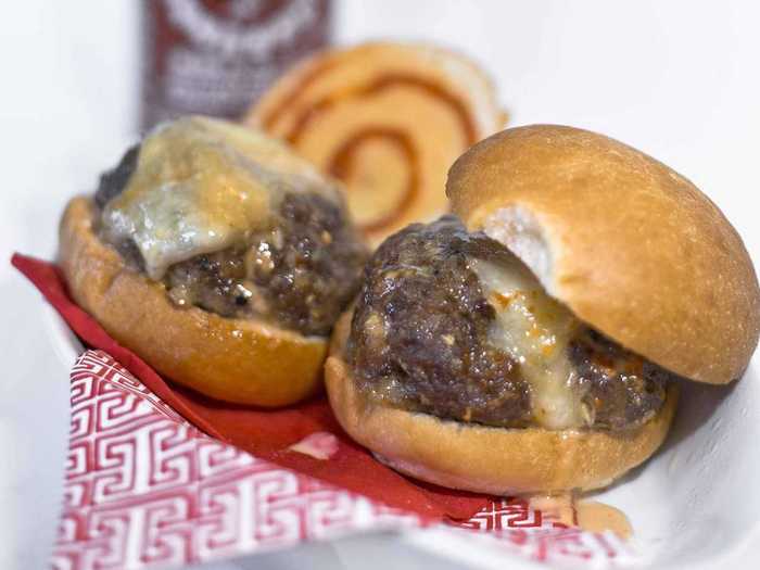 Sausage Sister’s Sriracha Sliders: “Great Balls of Fire” meatballs with Monterey Jack cheese at the center, served on a crusty slider bun with Sister’s Sweet ‘n’ Hot Sriracha Sauce.