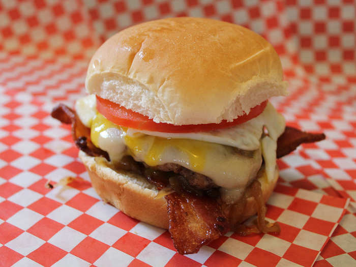 Smokey’s Breakfast Burger: Seasoned sausage and hamburger on a corn-dusted bun with applewood-smoked bacon, caramelized onions, melted provolone cheese, fried egg and a tomato slice.