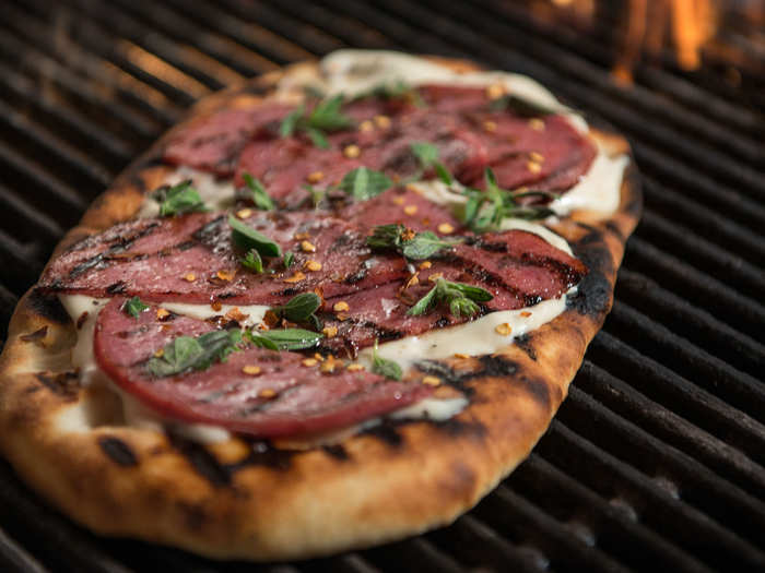 The Spicy Salami: Topped with thin-sliced salami, cheese, oregano and red pepper flakes. Grilled over an open flame for a crispy crust.