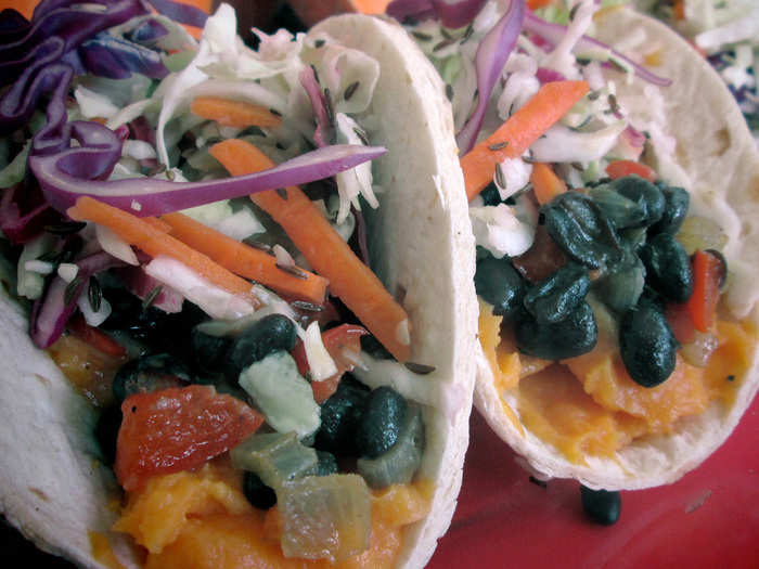 Sweet Potato Taco: Mashed sweet potatoes, black beans, sautéed onions and vinegar coleslaw wrapped in a flour tortilla.