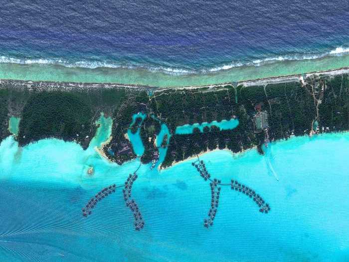 Chains of bungalows extend over the water at the Four Seasons Resort in Bora Bora, French Polynesia. In addition to the bungalows and beachfront villas, the complex is also home to the Ruahatu Lagoon Sanctuary — a research facility with more than 100 species of marine life.