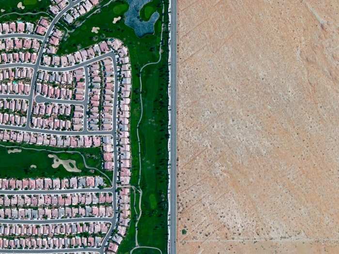 The lush fairways of the Sun City Palm Desert community in the Palm Springs area of California sit in stark contrast to the surrounding, barren desert.