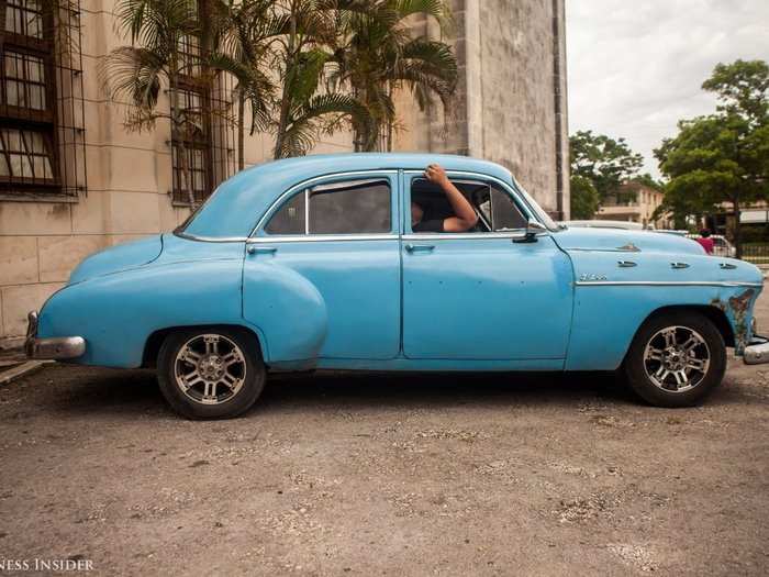 Until Fidel Castro and his revolutionaries took over the country in 1959, Cuba was once the top importer of North American-manufactured cars. The cars are commonly referred to as "yank tanks." We saw a man sleeping in the passenger seat of a "yank tank" outside of the second-largest church in Cuba, Iglesia de Jesús de Miramar.