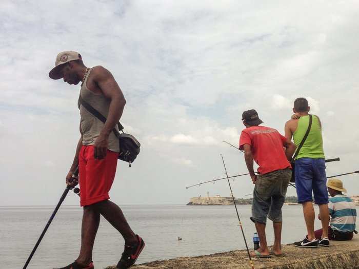 There were several groups of men fishing.