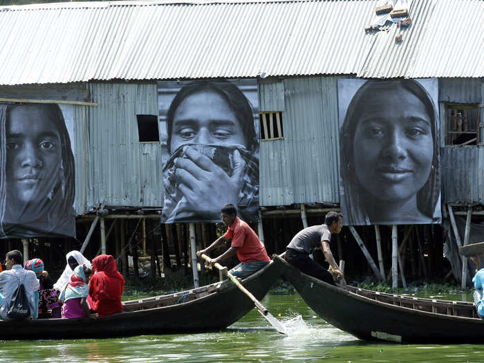 Here, boats carry local residents past the project, called "Dignity in Industry."